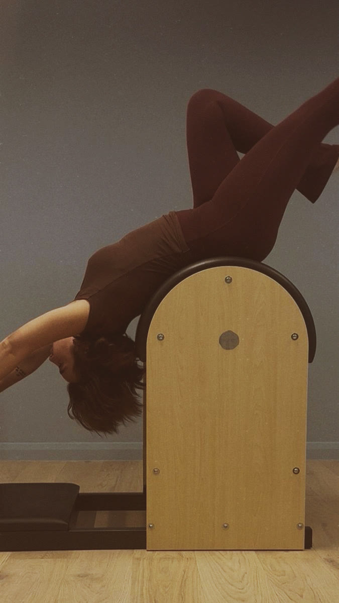 Backbend over the ladder barrel at NEUE, a Pilates studio in London Fields
